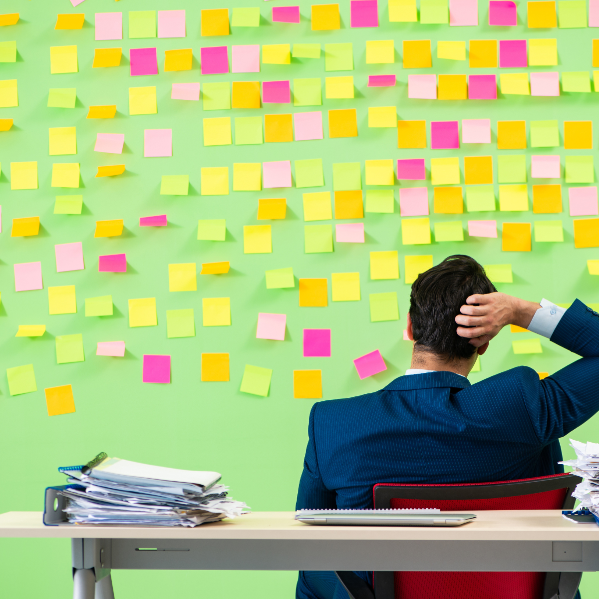 Business leader looking at various sticky notes